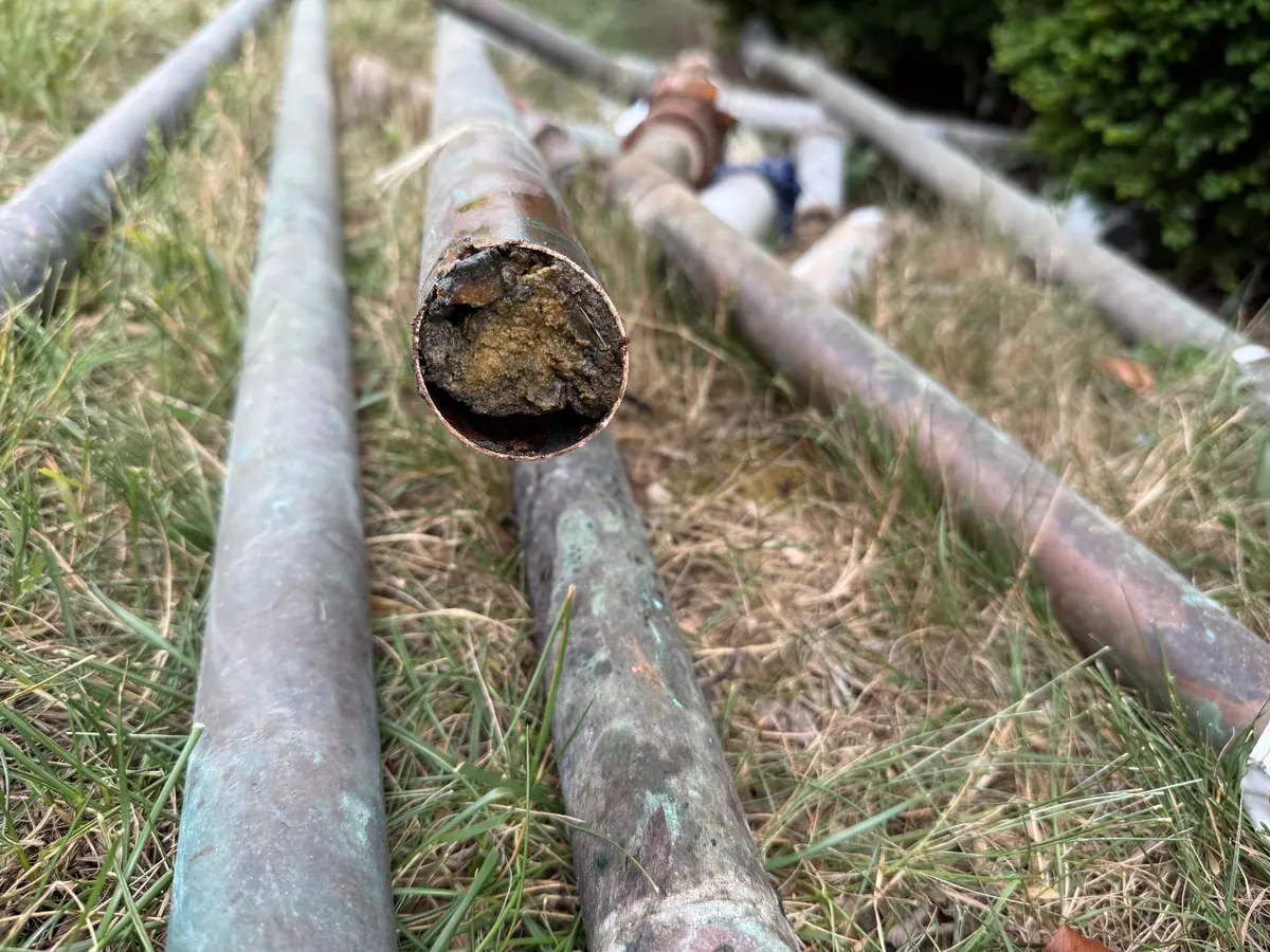 Plumbing repipe in Prince George's County, Maryland — corroded copper drain lines cut out by EMC Response showing interior blockage