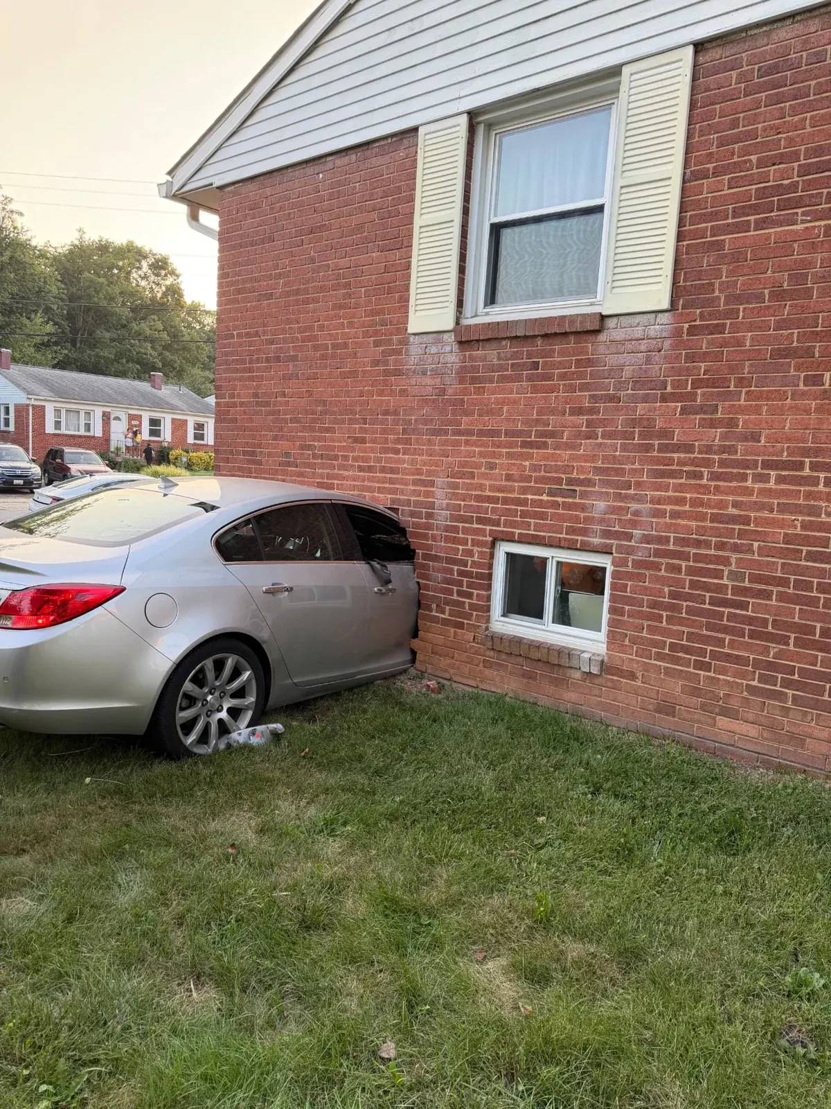 Vehicle against the brick exterior wall of a home at an EMC vehicle impact project