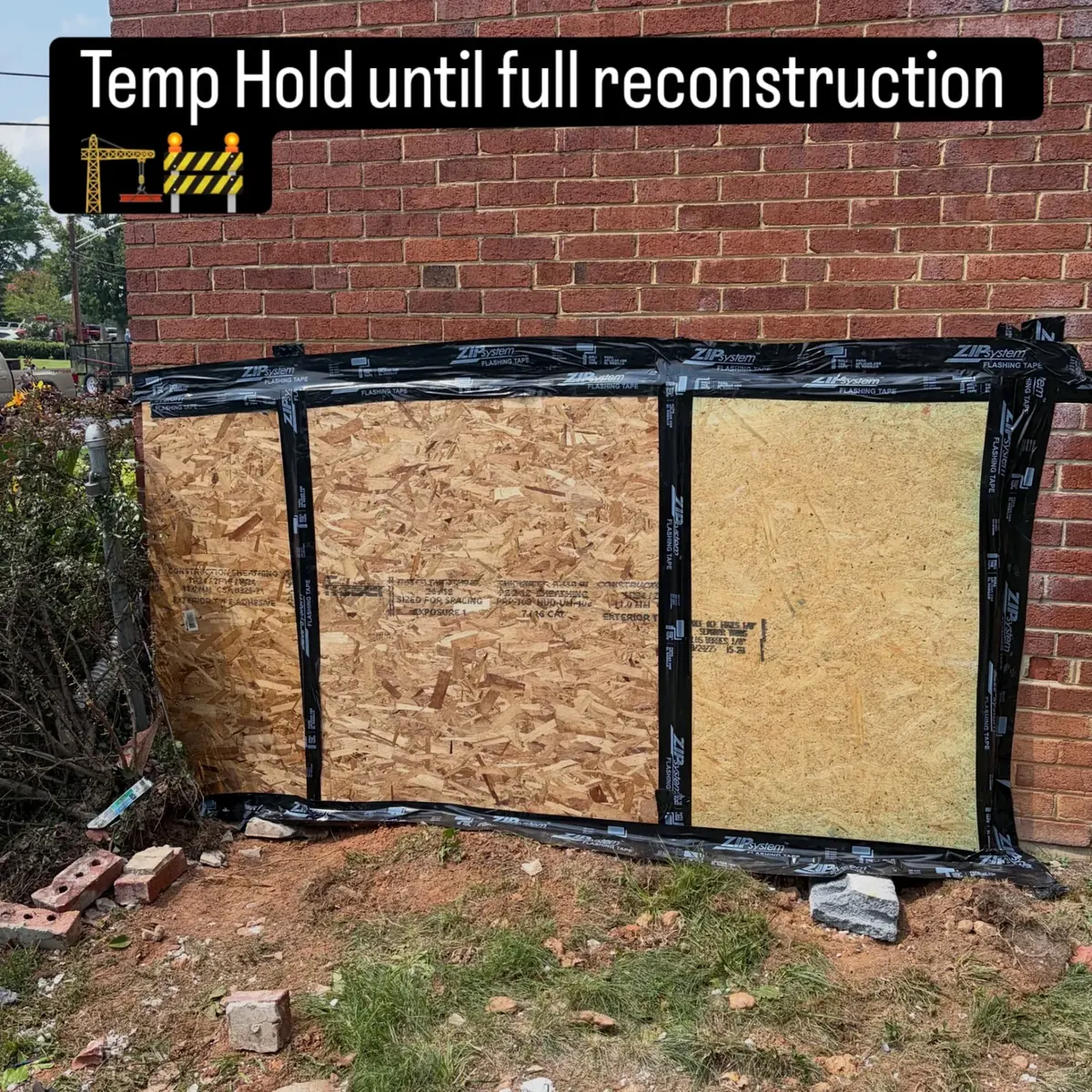 OSB board-up sealed with ZIP flashing tape over a vehicle impact opening in a brick wall by EMC Response