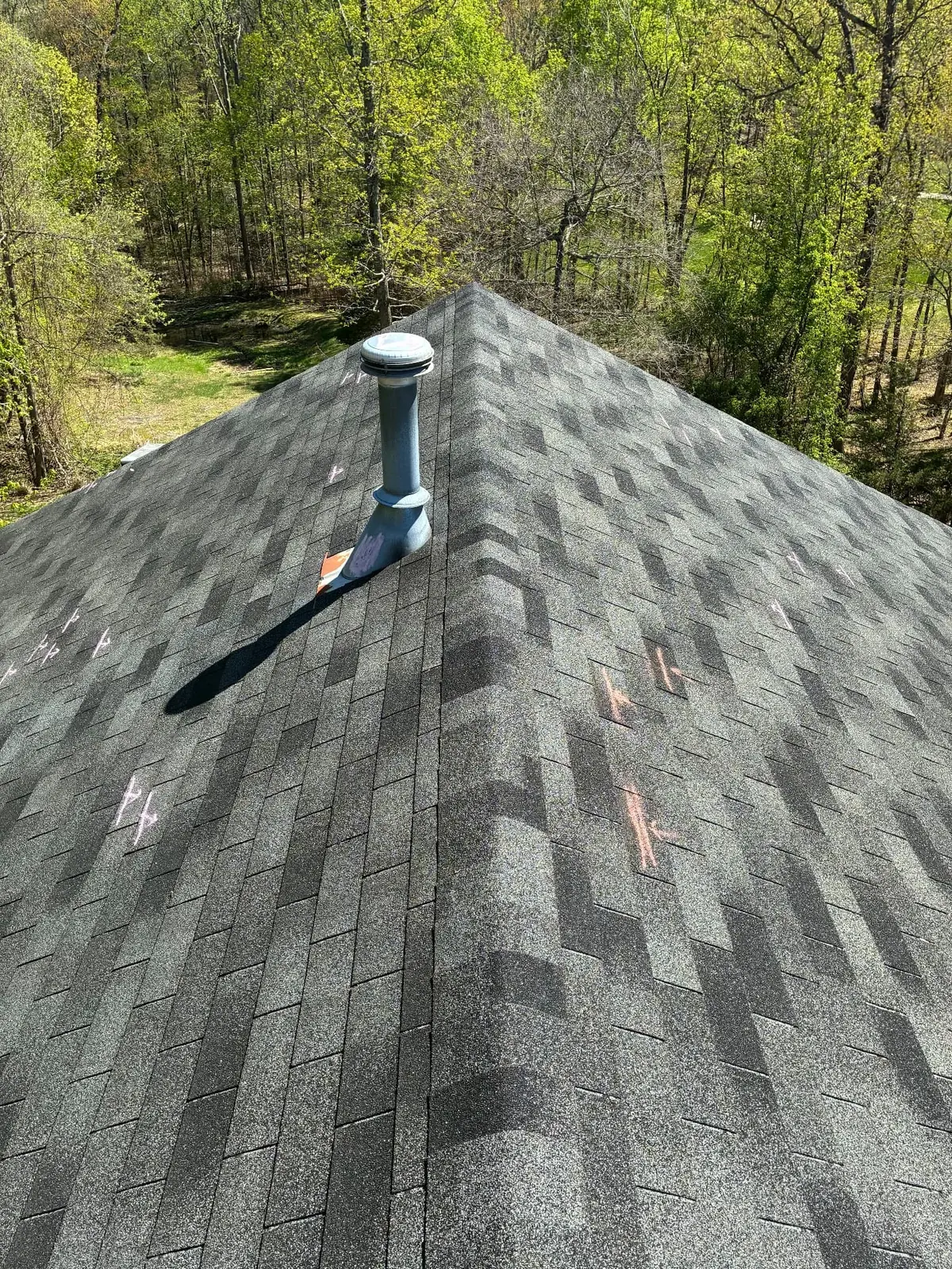 Hail damage roof inspection in Maryland — EMC Response chalk-marked hail impacts circled across architectural shingles for the insurance adjuster