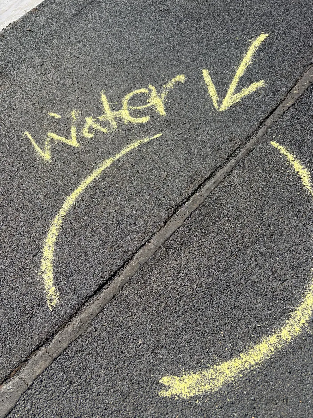 Flat roof membrane with water entry point circled and labeled in yellow chalk during an EMC roof leak inspection